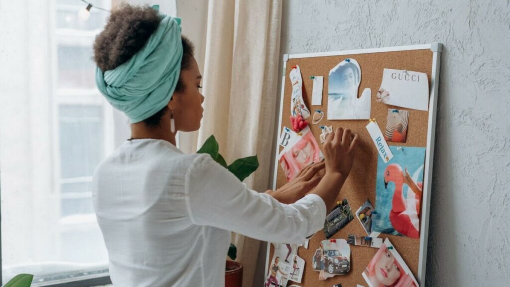 A woman business owner reviewing her vision board before her mid-year check-in